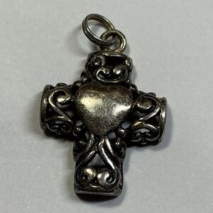 Sterling Silver Filigree Cross with a raised Heart Shape. 3/4 inches long
